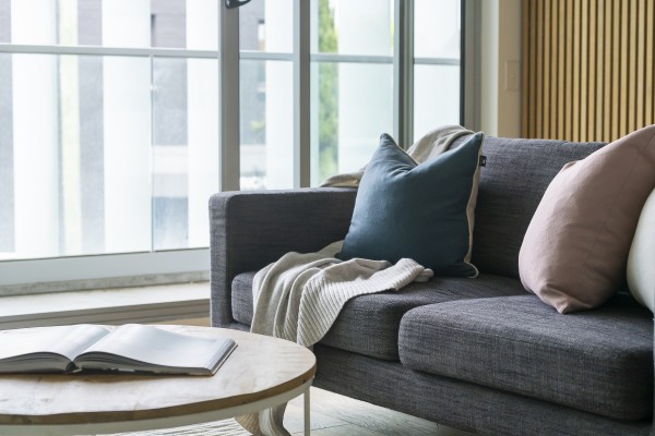 Grey couch with decorative cushions is one way to stage your home