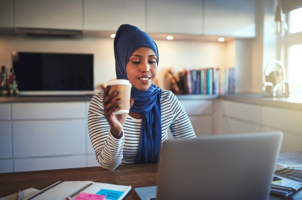 Woman on computer with coffee